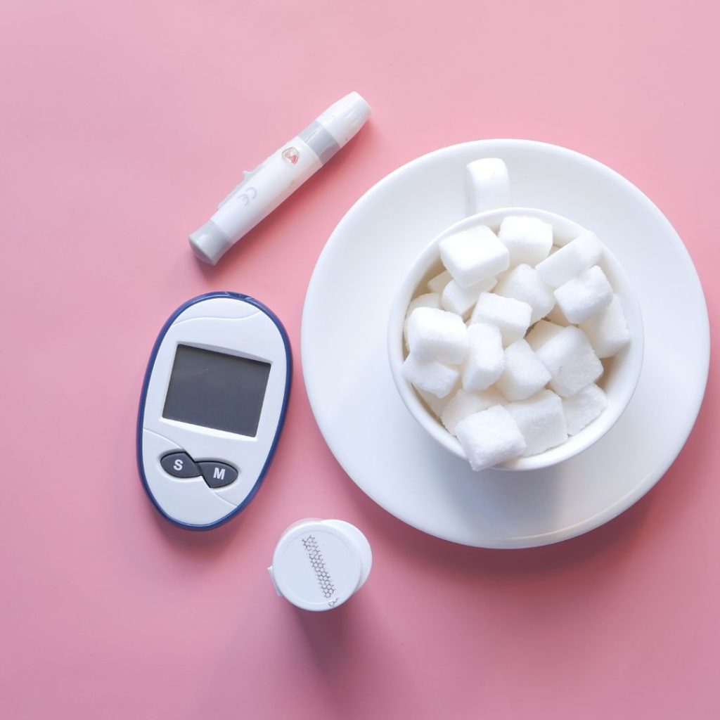 Diabetes and the sugar link, represented by a glucose monitor and a bowl of sugar cubes.